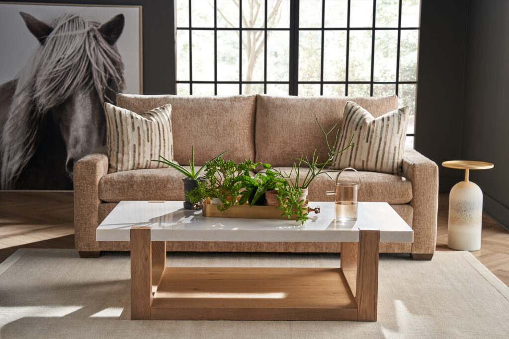Modern U Choose apartment sofa in a warm textured neutral, with track arms, in front of a black grid window.